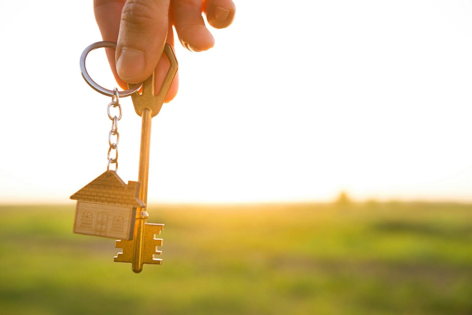 House key with keychain in hand.